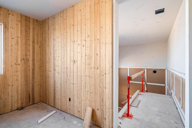 empty room featuring wood walls