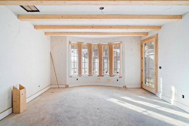 empty room with beamed ceiling