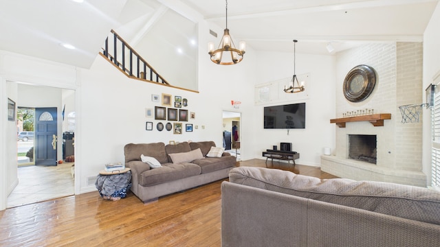 4615 94th St, Lubbock, TX 79424 - living room with a chandelier, hardwood / wood-style flooring, a fireplace, beam ceiling, and high vaulted ceiling