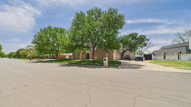 4615 94th St, Lubbock, TX 79424 - view of property hidden behind natural elements featuring a garage and driveway