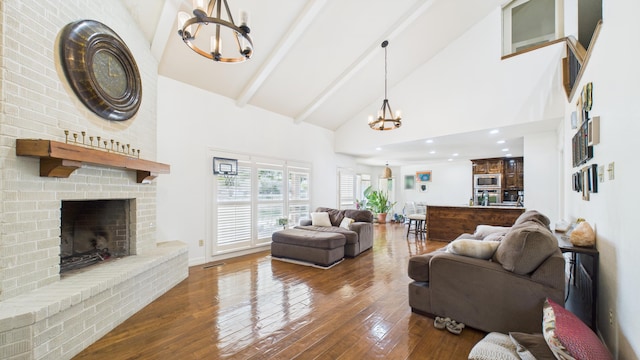 4615 94th St, Lubbock, TX 79424 - living room with a chandelier, high vaulted ceiling, a fireplace, beam ceiling, and hardwood / wood-style floors