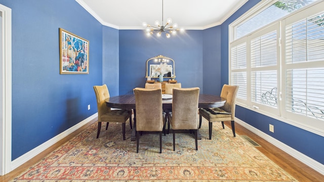4615 94th St, Lubbock, TX 79424 - dining area with a chandelier, wood finished floors, baseboards, healthy amount of natural light, and ornamental molding