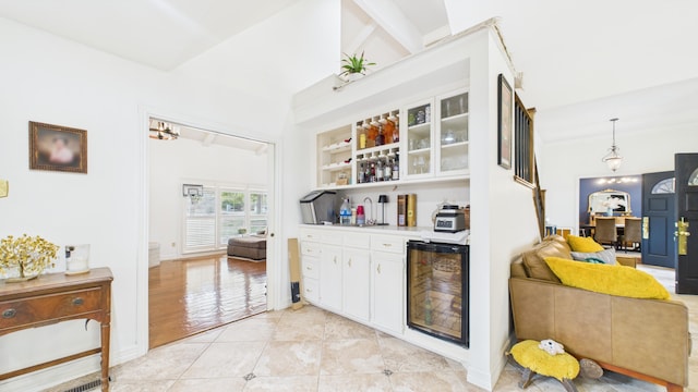 4615 94th St, Lubbock, TX 79424 - indoor dry bar with wine cooler, baseboards, and light tile patterned flooring