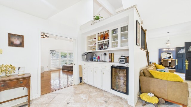 4615 94th St, Lubbock, TX 79424 - indoor dry bar with wine cooler, baseboards, and light tile patterned flooring