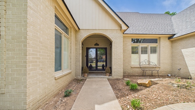 4615 94th St, Lubbock, TX 79424 - view of exterior entry with brick siding, roof with shingles, french doors, and board and batten siding