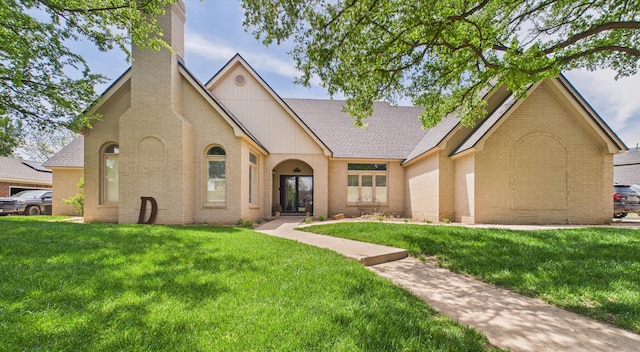 4615 94th St, Lubbock, TX 79424 - view of front of home featuring brick siding, a front yard, a chimney, and a shingled roof