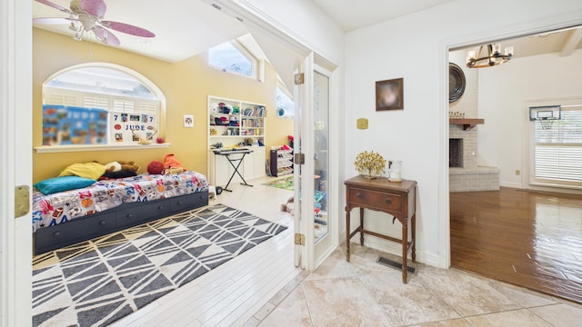 4615 94th St, Lubbock, TX 79424 - bedroom featuring a brick fireplace, wood finished floors, a ceiling fan, and baseboards