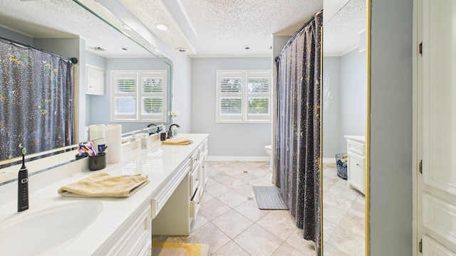 4615 94th St, Lubbock, TX 79424 - full bathroom with a textured ceiling, double vanity, toilet, baseboards, and tile patterned floors