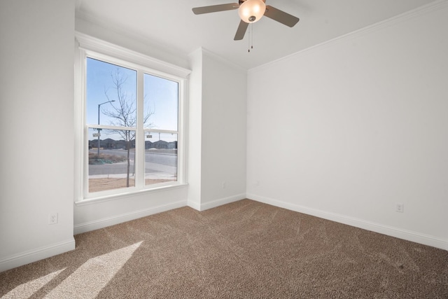 carpeted spare room featuring crown molding and ceiling fan