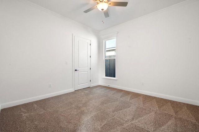 empty room featuring ceiling fan, ornamental molding, and carpet floors