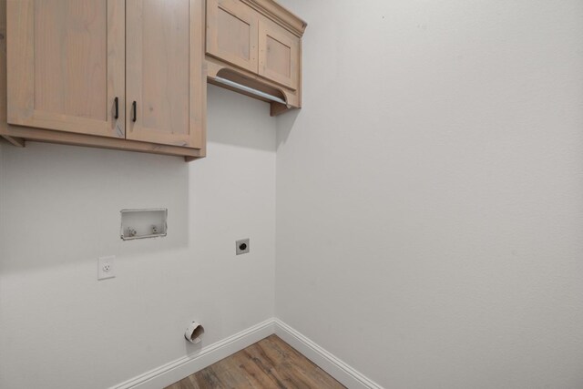 washroom featuring cabinets, hardwood / wood-style floors, electric dryer hookup, and washer hookup