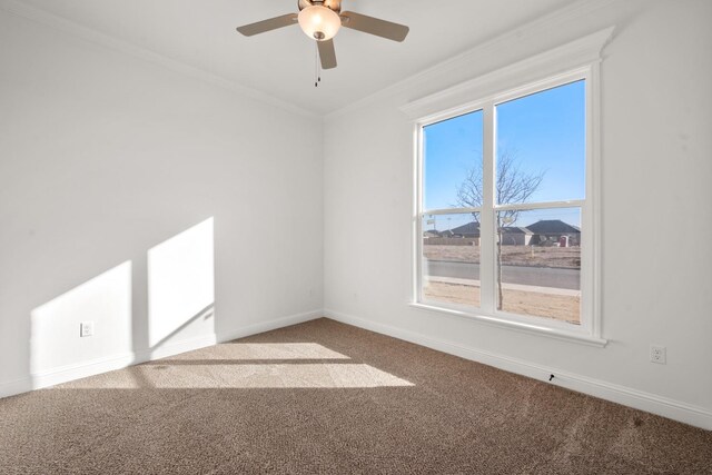 empty room featuring crown molding, ceiling fan, and carpet