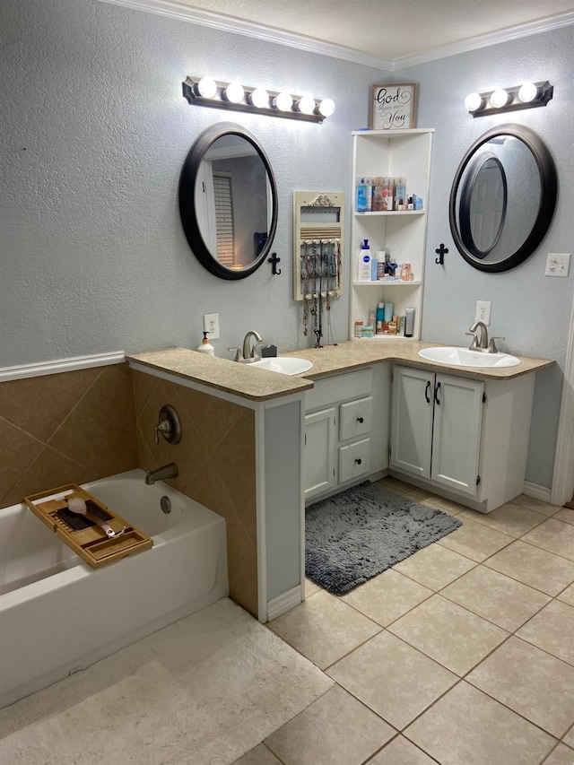 bathroom with tile patterned flooring, vanity, a bathtub, and ornamental molding