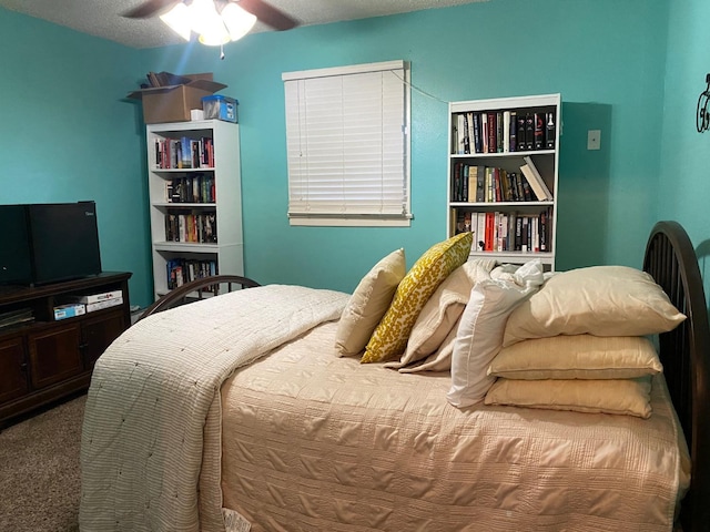 bedroom featuring a textured ceiling, ceiling fan, and carpet flooring