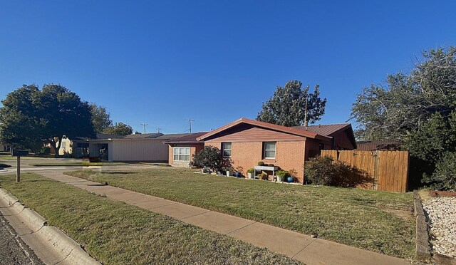 single story home featuring a front lawn