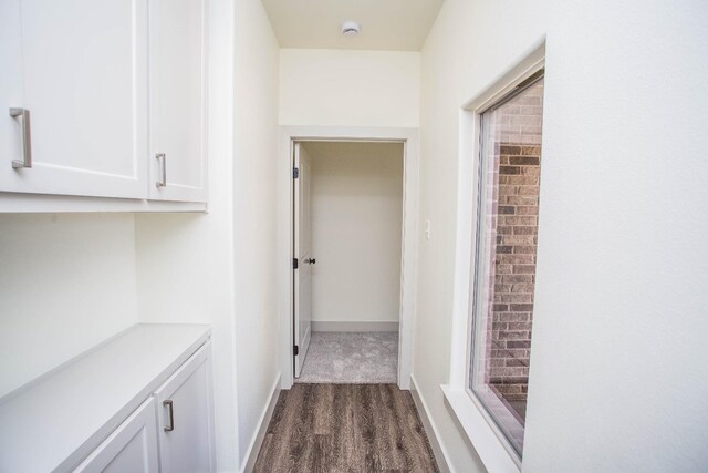 corridor featuring dark wood-type flooring