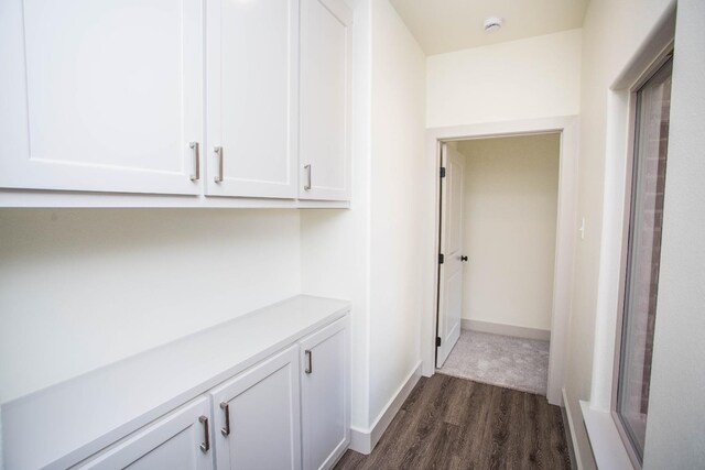 hall with dark hardwood / wood-style flooring