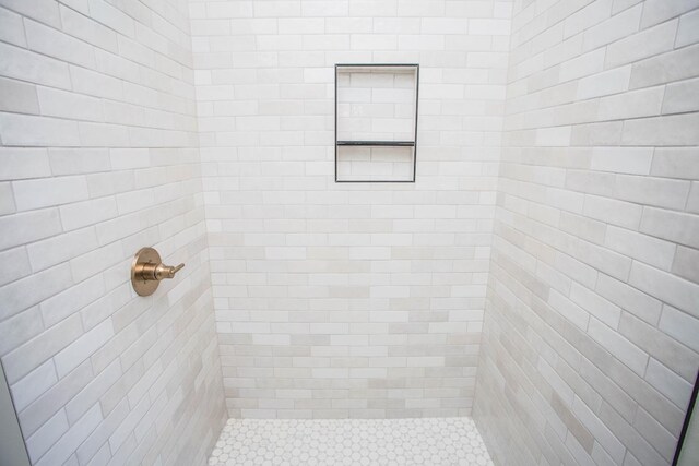 bathroom with a tile shower