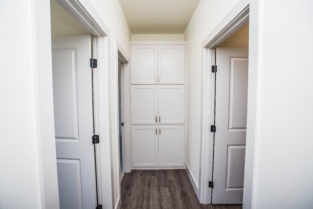 corridor with dark hardwood / wood-style flooring