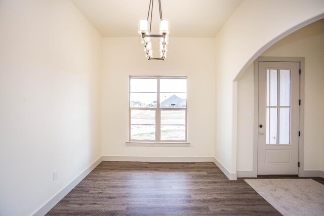 entryway featuring dark hardwood / wood-style floors and a chandelier