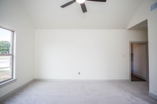 carpeted spare room with lofted ceiling, a healthy amount of sunlight, and ceiling fan