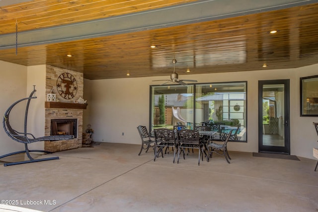11604 Uxbridge Ave, Lubbock, TX 79424 - view of patio / terrace with an outdoor stone fireplace, ceiling fan, and outdoor dining area