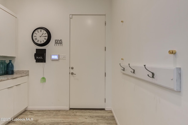 11604 Uxbridge Ave, Lubbock, TX 79424 - doorway featuring light wood-style floors and baseboards