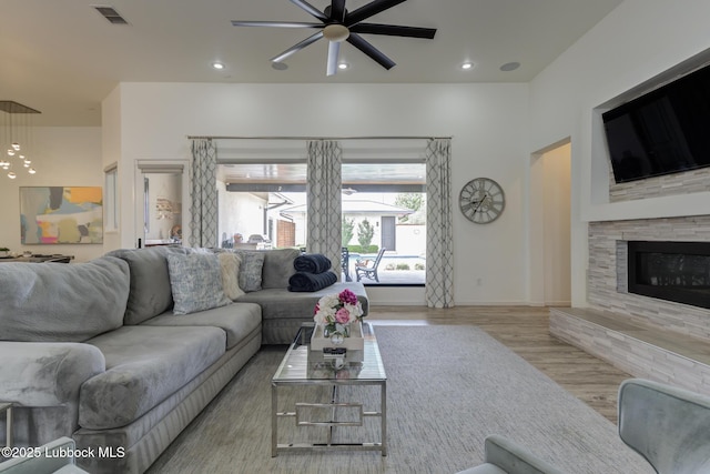 11604 Uxbridge Ave, Lubbock, TX 79424 - living room with wood finished floors, a ceiling fan, recessed lighting, and a fireplace