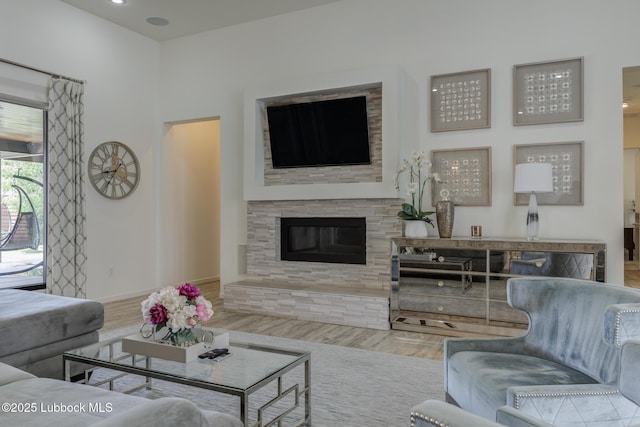 11604 Uxbridge Ave, Lubbock, TX 79424 - living room with wood finished floors and a glass covered fireplace