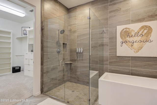 11604 Uxbridge Ave, Lubbock, TX 79424 - full bath with a shower stall, a tub, and a spacious closet