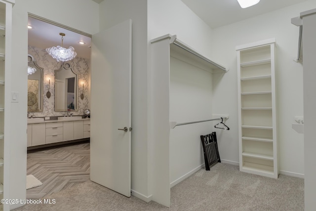 11604 Uxbridge Ave, Lubbock, TX 79424 - spacious closet with a chandelier and light colored carpet