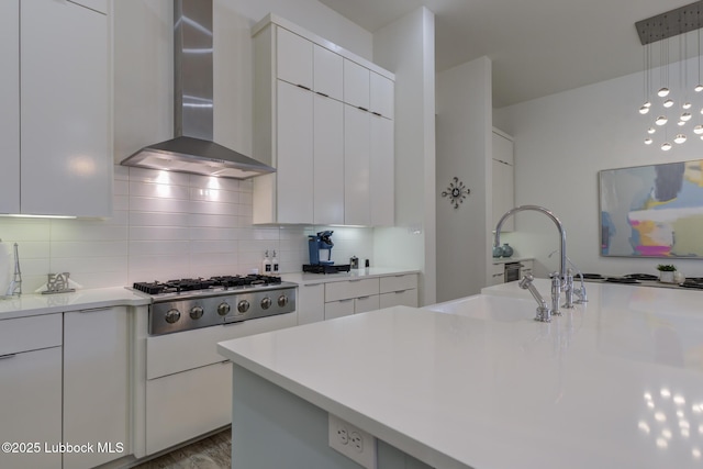 11604 Uxbridge Ave, Lubbock, TX 79424 - kitchen with wall chimney exhaust hood, stainless steel gas cooktop, and modern cabinets