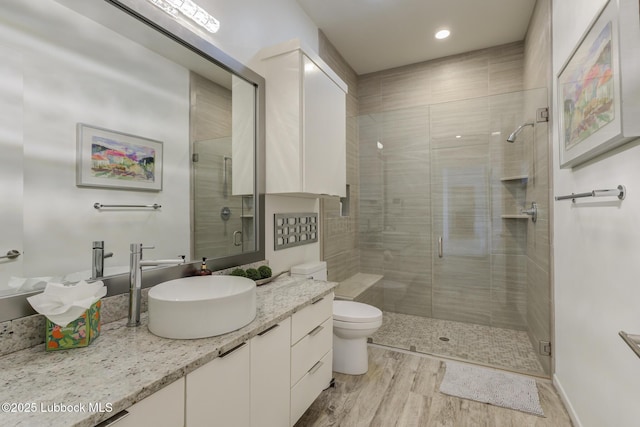 11604 Uxbridge Ave, Lubbock, TX 79424 - full bathroom featuring vanity, a shower stall, wood finished floors, and recessed lighting