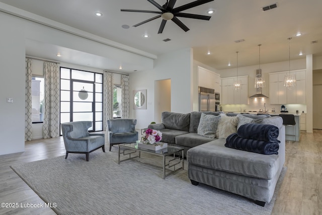 11604 Uxbridge Ave, Lubbock, TX 79424 - living area featuring a ceiling fan, light wood-type flooring, recessed lighting, and a chandelier