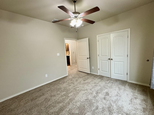 unfurnished bedroom featuring ceiling fan, light colored carpet, and a closet