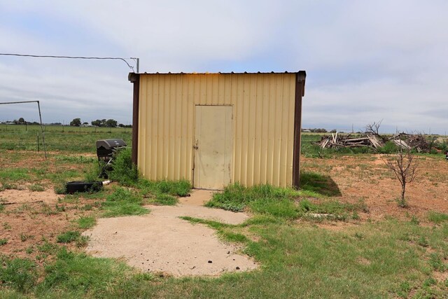 view of outdoor structure with a rural view