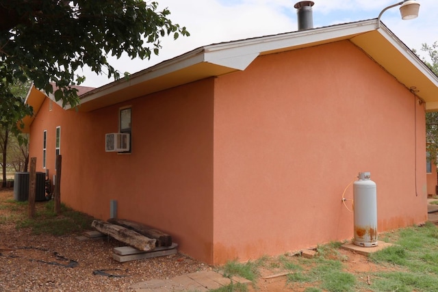 view of home's exterior featuring cooling unit and central AC unit