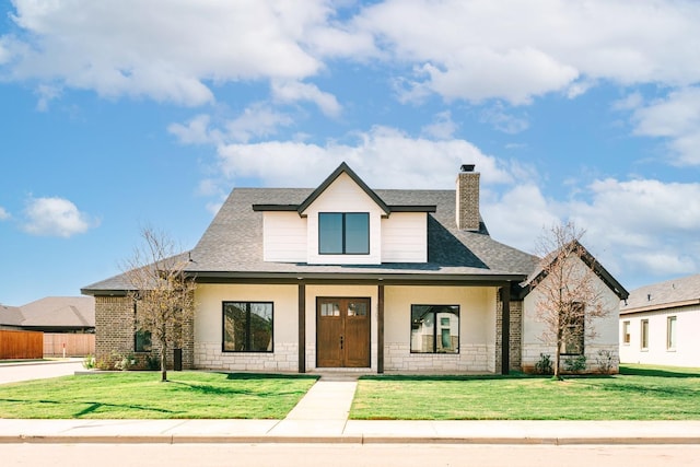 view of front of house with covered porch and a front yard