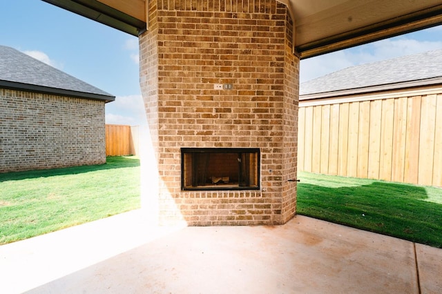 view of patio featuring an outdoor brick fireplace