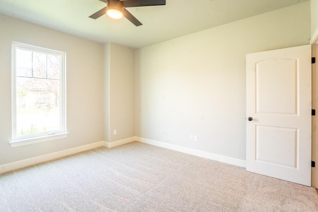 empty room featuring carpet flooring and ceiling fan