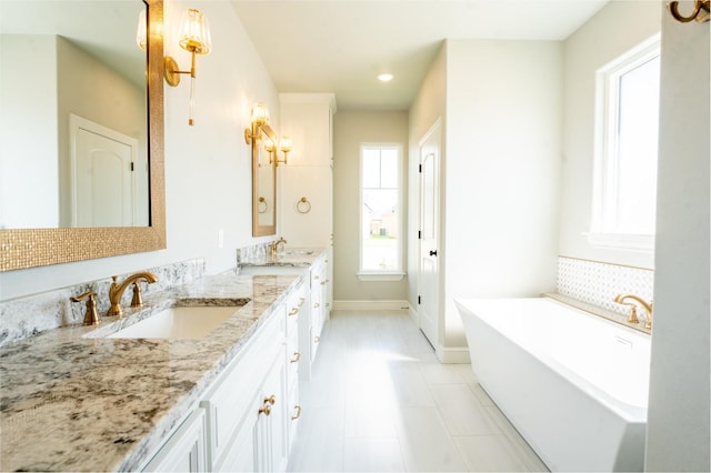 bathroom featuring tile patterned floors, vanity, and a bathing tub