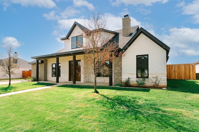 back of house featuring a lawn