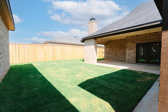 view of yard featuring french doors and a patio area