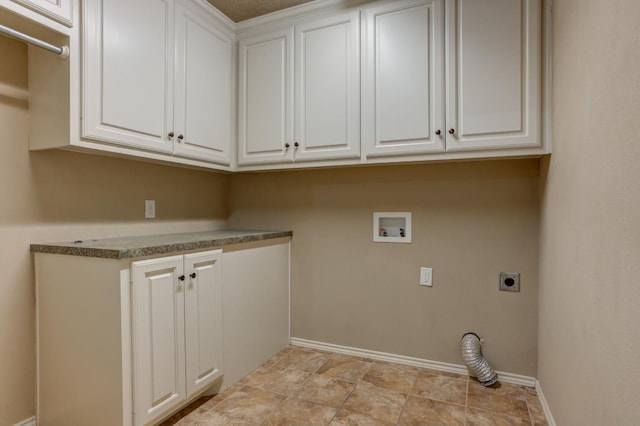 clothes washing area with cabinets, electric dryer hookup, and washer hookup