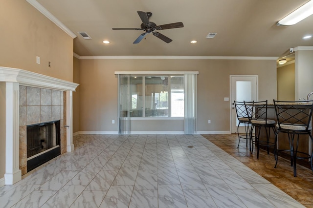 unfurnished living room featuring crown molding, ceiling fan, and a fireplace