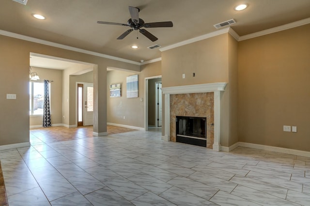 unfurnished living room featuring ornamental molding, a tile fireplace, and ceiling fan