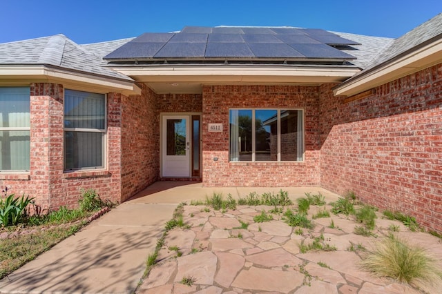 doorway to property featuring solar panels