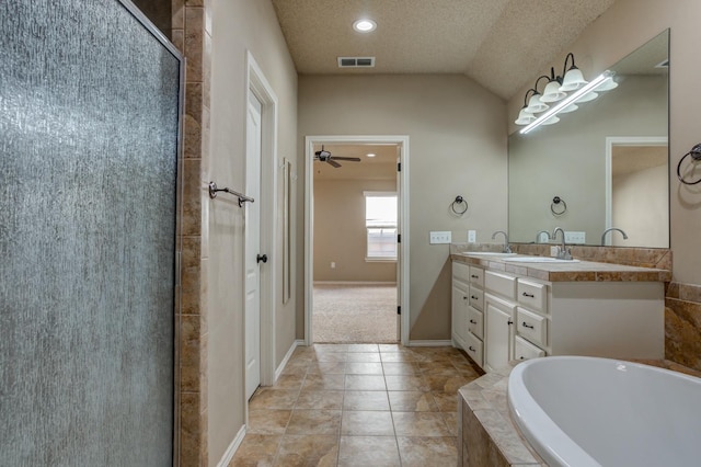 bathroom featuring lofted ceiling, tile patterned flooring, vanity, a textured ceiling, and separate shower and tub