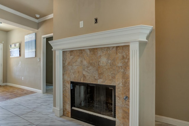 details featuring ornamental molding and a tile fireplace