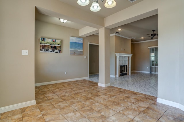 unfurnished living room with a tiled fireplace, ornamental molding, ceiling fan with notable chandelier, and light tile patterned floors